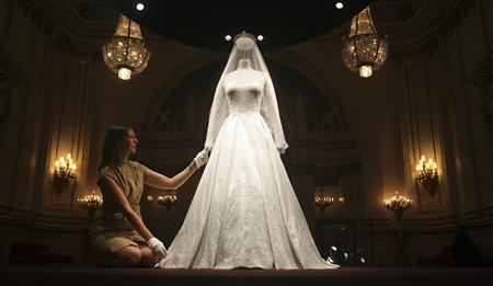 The wedding dress of Britain's Catherine, Duchess of Cambridge is seen as it is prepared for display at Buckingham Palace in London The wedding dress of Britain's Catherine, Duchess of Cambridge is seen as it is prepared for display at Buckingham Palace in London