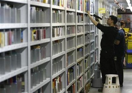 Workers scan goods at the Amazon warehouse in Leipzig