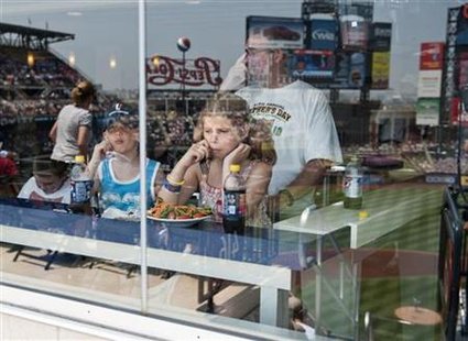 The stadium is reflected in the glass as young fans sit in an air-conditioned resturaunt as the New York Mets play the St. Louis Cardinals i The stadium is reflected in the glass as young fans sit in an air-conditioned resturaunt as the New York Mets play the St. Louis Cardinals i