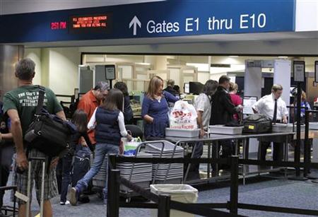 Passengers line up at a security checkpoint operated by the TSA at Fort Lauderdale-Hollywood International Airport in Fort Lauderdale
