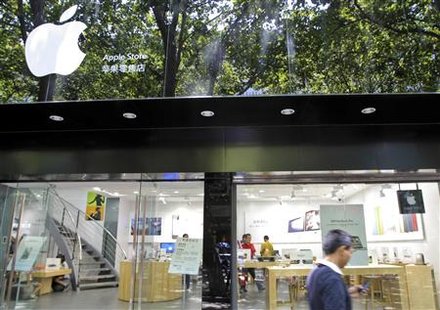 A pedestrian uses his cell phone as he walks past a fake Apple store in Kunming, Yunnan province A pedestrian uses his cell phone as he walks past a fake Apple store in Kunming, Yunnan province