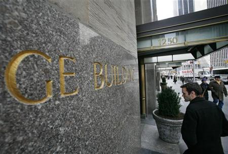 A man enters the General Electric building at 1250 Avenue of the Americas, also known as 30 Rockefeller Plaza in New York A man enters the General Electric building at 1250 Avenue of the Americas, also known as 30 Rockefeller Plaza in New York