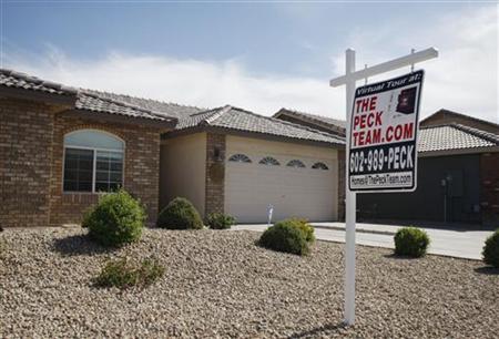 A real estate sales sign sits outside of a house for sale in Phoenix, Arizona A real estate sales sign sits outside of a house for sale in Phoenix, Arizona