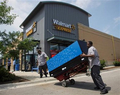 Workers move a vending machine into position outside a new Walmart Express store in Chicago Workers move a vending machine into position outside a new Walmart Express store in Chicago