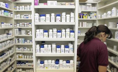 A pharmacy employee looks for medication as she works to fill a prescription while working at a pharmacy in New York A pharmacy employee looks for medication as she works to fill a prescription while working at a pharmacy in New York