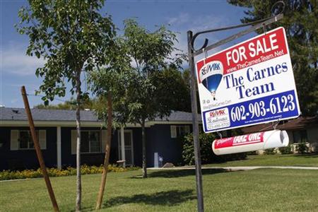 A real estate sales sign sits outside of a house for sale in Phoenix, Arizona A real estate sales sign sits outside of a house for sale in Phoenix, Arizona