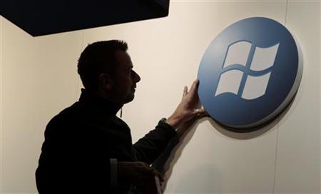 A worker adjusts a logo on the Microsoft stand at the CeBIT computer fair in Hanover A worker adjusts a logo on the Microsoft stand at the CeBIT computer fair in Hanover