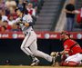 Milwaukee Brewers' Ryan Braun follows through to hit a grand slam home run as the Los Angeles Angels catcher Mike Napoli (R) also watches in the third inning of their MLB interleague baseball game in Anaheim, California June 14, 2010. REUTERS