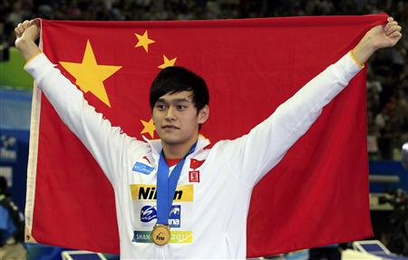 China's Sun poses with his gold medal and national flag after men's 1500m freestyle final at 14th FINA World Championships in Shangha China's Sun poses with his gold medal and national flag after men's 1500m freestyle final at 14th FINA World Championships in Shangha