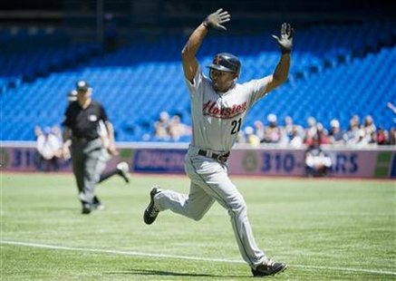 Astros baserunner Bourn puts his hands up to avoid a hit ball against the Blue Jays during their Interleague League MLB baseball game in Tor Astros baserunner Bourn puts his hands up to avoid a hit ball against the Blue Jays during their Interleague League MLB baseball game in Tor