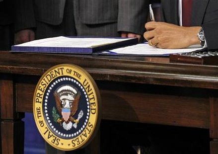 President Barack Obama signs into law a bill at the Eisenhower Executive Office Building in Washington