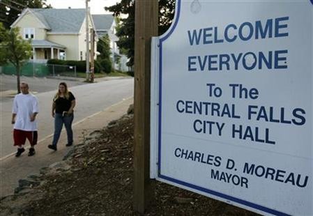 Pedestrians pass City Hall in Central Falls Pedestrians pass City Hall in Central Falls