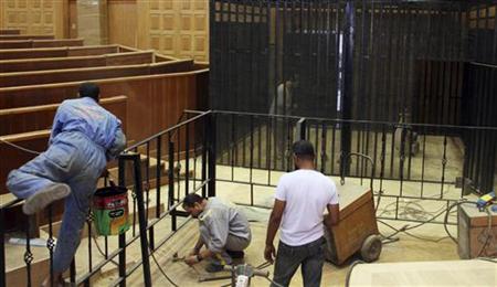 Workers prepare a cage enclosure in a courtroom for the upcoming trial of former Egyptian President Mubarak in Cairo Workers prepare a cage enclosure in a courtroom for the upcoming trial of former Egyptian President Mubarak in Cairo