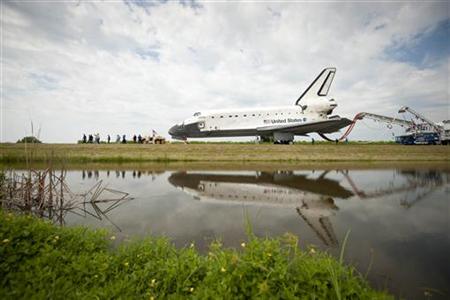 Space shuttle Atlantis (STS-135) is rolled over to the Obiter Processing Facility (OPF) shortly after landing at NASA's Kennedy Space Center Space shuttle Atlantis (STS-135) is rolled over to the Obiter Processing Facility (OPF) shortly after landing at NASA's Kennedy Space Center