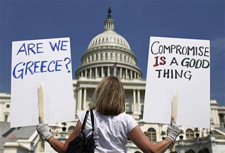 A demonstrator holds placards to protest U.S. debt in front of the Capitol in Washington