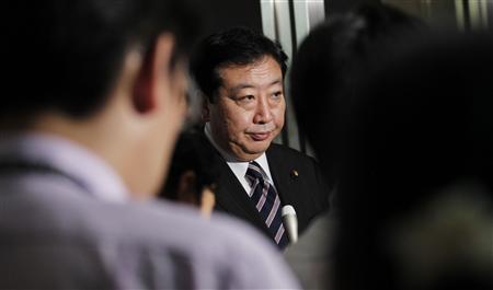 Finance Minister Yoshihiko Noda is surrounded by reporters in Tokyo Finance Minister Yoshihiko Noda is surrounded by reporters in Tokyo