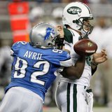 Detroit Lions defensive end Cliff Avril (L) strips the ball from New York Jets QB Mark Sanchez (R) during the first half of their game in Detroit on November 7, 2010. REUTERS