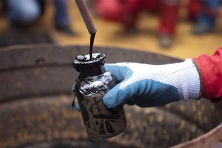 A worker collects crude oil sample at an oil well operated by Venezuela's state oil company PDVSA in Morichal A worker collects crude oil sample at an oil well operated by Venezuela's state oil company PDVSA in Morichal