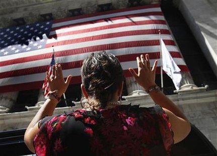A woman does yoga outside the New York Stock Exchange A woman does yoga outside the New York Stock Exchange