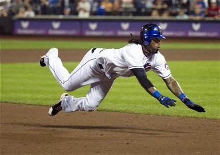 New York Mets Jose Reyes dives into third base as he hits triple against Oakland Athletics in New York New York Mets Jose Reyes dives into third base as he hits triple against Oakland Athletics in New York