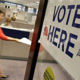 A voter handing in a completed ballot. (Reuters) A voter handing in a completed ballot. (Reuters)