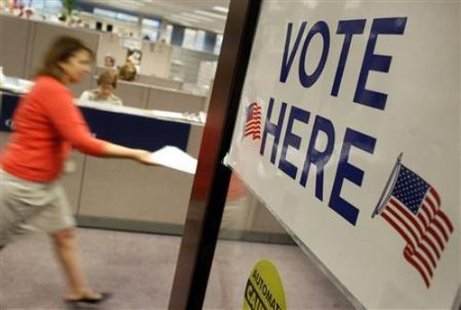 A voter handing in a completed ballot. (Reuters) A voter handing in a completed ballot. (Reuters)