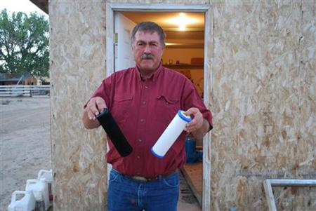 Jeff Locker, a Wyoming farmer, displays water filters from his well Jeff Locker, a Wyoming farmer, displays water filters from his well