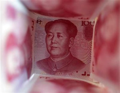 A 100 Yuan note is surrounded by other 100 Yuan notes in this picture illustration in Beijing A 100 Yuan note is surrounded by other 100 Yuan notes in this picture illustration in Beijing