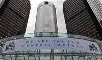 A banner hangs on the front of the General Motors Co world headquarters announcing GM's return to NYSE in Detroit