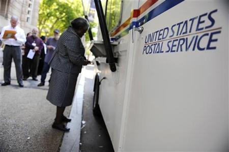On the deadline day for US citizens to file their income tax returns, a woman stands at the front of the line at a mobile post office near t On the deadline day for US citizens to file their income tax returns, a woman stands at the front of the line at a mobile post office near t