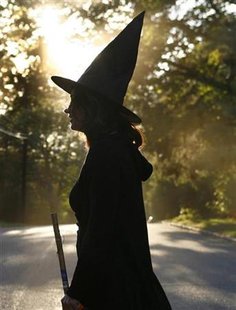 A woman dressed as a witch walks along the street during Halloween celebrations in Port Washington A woman dressed as a witch walks along the street during Halloween celebrations in Port Washington