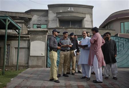Police and security officials gather outside the residence of an American citizen after he was kidnapped in Lahore Police and security officials gather outside the residence of an American citizen after he was kidnapped in Lahore
