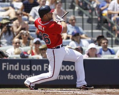 Braves batter Uggla watches his broken bat sacrifice fly in the first inning, scoring a run off of Cubs pitcher Garza at their MLB National Braves batter Uggla watches his broken bat sacrifice fly in the first inning, scoring a run off of Cubs pitcher Garza at their MLB National