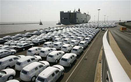 New VW cars are covered with protective covers before loaded for export on a transport ship at the harbour in Emden New VW cars are covered with protective covers before loaded for export on a transport ship at the harbour in Emden