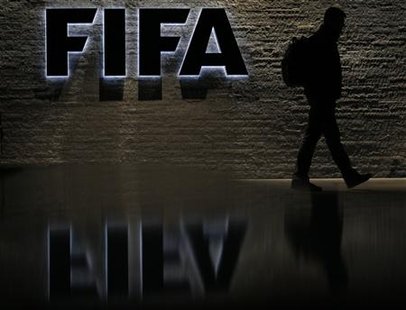 File photo of a silhouetted man walking past the main entrance of FIFA headquarters the Home of FIFA in Zurich File photo of a silhouetted man walking past the main entrance of FIFA headquarters the Home of FIFA in Zurich