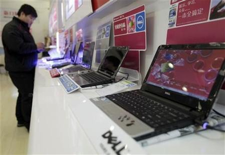 A customer looks at laptops at a Dell outlet in Beijing A customer looks at laptops at a Dell outlet in Beijing