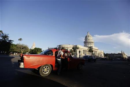 A man boards a private-licensed taxi near Havana's Capitol building A man boards a private-licensed taxi near Havana's Capitol building