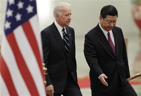 Vice President Biden is ushered to the podium by his Chinese counterpart Xi during a welcome ceremony at the Great Hall of the People in Bei