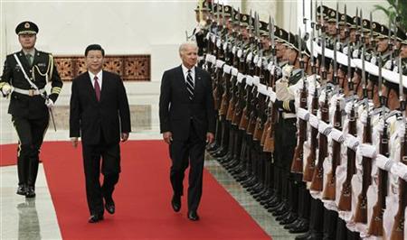 U.S. Vice President Biden and his Chinese counterpart Xi review the guards of honour during a welcome ceremony at the Great Hall of the Peop U.S. Vice President Biden and his Chinese counterpart Xi review the guards of honour during a welcome ceremony at the Great Hall of the Peop