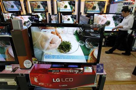 An employee of an electronics shop works behind an LG Electronics' LCD television set in Seoul An employee of an electronics shop works behind an LG Electronics' LCD television set in Seoul