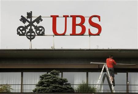A worker stands on a ladder under the logo of Swiss bank UBS at the company's headquarters in Zurich A worker stands on a ladder under the logo of Swiss bank UBS at the company's headquarters in Zurich