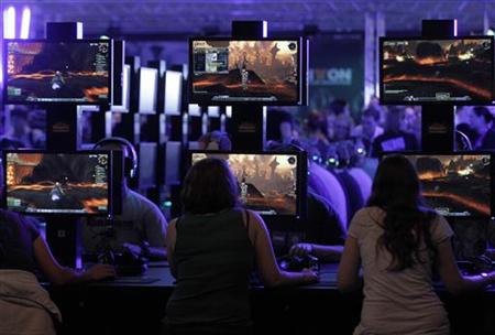 Visitors play ''World of Warcraft'' at an exhibition stand during the Gamescom 2011 fair in Cologne Visitors play ''World of Warcraft'' at an exhibition stand during the Gamescom 2011 fair in Cologne