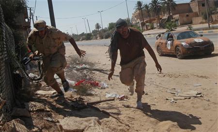 Libyan rebel fighters run for cover from incoming fire as they advance through the town of Maia, 25 kms (15 miles) from Tripoli Libyan rebel fighters run for cover from incoming fire as they advance through the town of Maia, 25 kms (15 miles) from Tripoli
