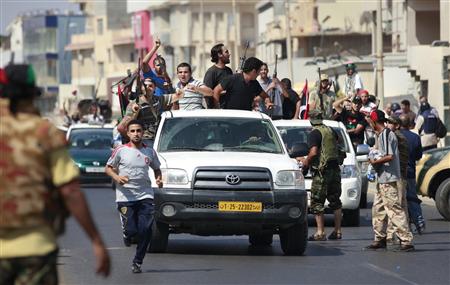 Libyan rebel fighters celebrate as they drive through Tripoli's Qarqarsh district Libyan rebel fighters celebrate as they drive through Tripoli's Qarqarsh district
