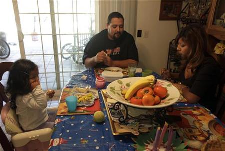 Thelma Zambrano eats lunch with her husband Jesse Torres and daughter Vida Torres, 2, at their home in Santa Ana, California Thelma Zambrano eats lunch with her husband Jesse Torres and daughter Vida Torres, 2, at their home in Santa Ana, California