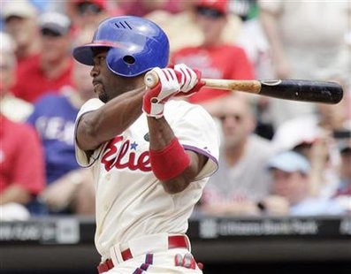 Phillies' Rollins follows through on his swing hitting a base hit off of Athletics' Outman in the fifth inning during their MLB Interleague Phillies' Rollins follows through on his swing hitting a base hit off of Athletics' Outman in the fifth inning during their MLB Interleague