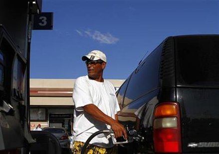 A motorist pumps fuel into his vehicle at JJ's Express Gas Plus station in Phoenix gas station in Phoenix A motorist pumps fuel into his vehicle at JJ's Express Gas Plus station in Phoenix gas station in Phoenix