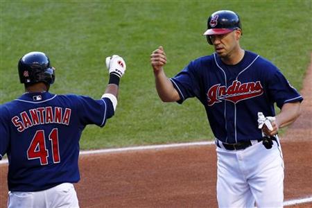 Cleveland Indians Hafner is greeted by Santana after scoring on an Toronto Blue Jays error during their MLB American League baseball game in Cleveland Indians Hafner is greeted by Santana after scoring on an Toronto Blue Jays error during their MLB American League baseball game in