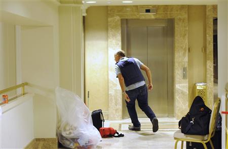 A member of the media runs because due to the noise from gunfire at the Rixos hotel in Tripoli A member of the media runs because due to the noise from gunfire at the Rixos hotel in Tripoli