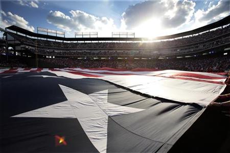 American flag used at the recent All-Star game is unfurl during the national anthem before the Texas Rangers and Toronto Blue Jays MLB Ameri American flag used at the recent All-Star game is unfurl during the national anthem before the Texas Rangers and Toronto Blue Jays MLB Ameri